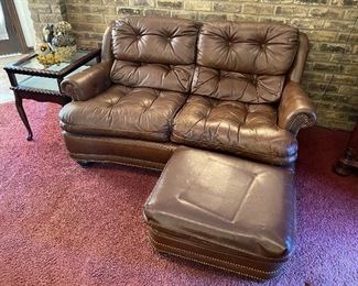 Leather tufted loveseat and matching ottoman