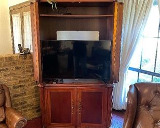 Flat screen Samsung TV and large armoire