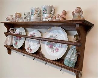 Shelf not for sale but the piano babies, plates and frozen Charlottes are for sale.