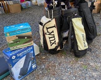 Many new golf balls. Ladies set of clubs, Men set of golf clubs, plus empty carry bag and cover, plus more golf items.