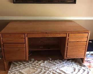 Hard wood desk with file cabinet draw on right side.