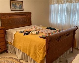 Vintage carved oak head and foot board bed excellent condition, braided rug, blankets and sheets.