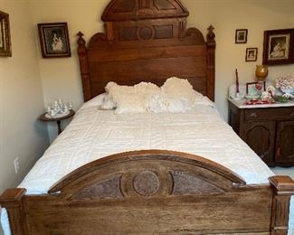 Antique walnut Victorian bed, vintage pictures in walnut frames, marble top side table and round top side table.