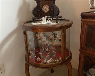 Display round glass table, battery clock, candle holder and collection of miniature animals. 
