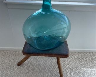 3 legged primitive stool and antique big blue bottle