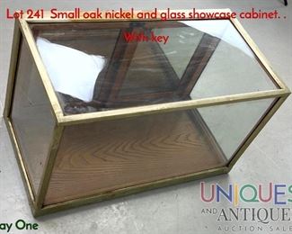 Lot 241 Small oak nickel and glass showcase cabinet. . With key