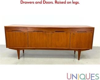 Lot 329 Danish Modern Teak Credenza Sideboard. Drawers and Doors. Raised on legs.