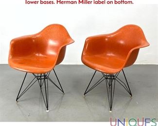 Lot 398 Pr Orange Fiberglass Eames arm chairs with Eiffel Tower bases. Herman Miller label on bottom.