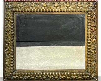 Lot 704 Antique Beveled Mirror with Decorative Bronze Frame Over Wood. 