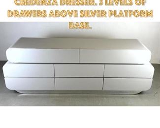 Lot 1292 White Laminate Modernist Credenza Dresser. 3 Levels of drawers above silver platform base.