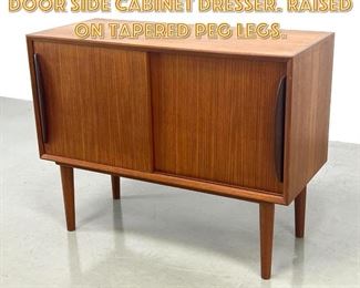 Lot 1596 Small Danish Teak Sliding Door Side Cabinet Dresser. Raised on tapered peg legs. 