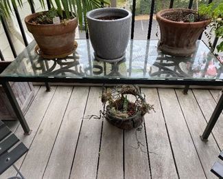 Glass top coffee table / plant stand. Iron Base. Measures 18.5" wide x 45.5" long x 18" tall with the glass. Asking $50. Planters Left to Right. Terra Cotta $3. Glazed planter $3. Decorative Terra Cotta asking $10. 