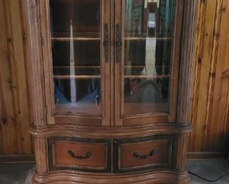 Cabinet has light glass front doors