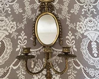 Look deep into this mirrored wall sconce and you'll see the number one estate sale provider.... 