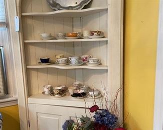Corner cabinet with tea cups galore