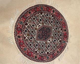 Round oriental carpet.
