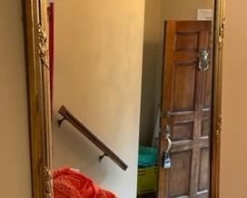 French Neoclassical style black and gold demi-lune console mirror.