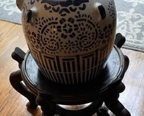 Vintage Chinese blue and white glazed stoneware pottery water jug on wooden stand.