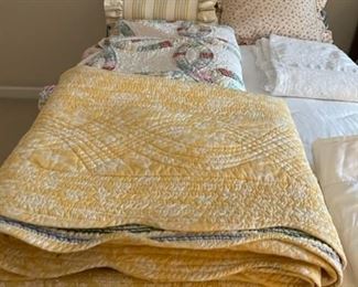 Assorted quilts and bedding.