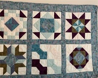 Assorted quilts and bedding.