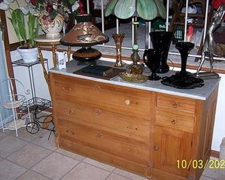 Marble top dresser, plant stands, black amethyst, green slag glass lamp and more