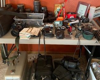 35mm Minolta camera, small digital cameras, several different size lenses, filters