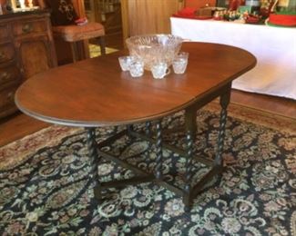 Drop leaf barley twist dining table and colorfully patterned rug