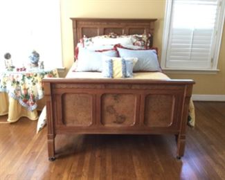 Antique full size bed with headboard and footboard with burled wood inset panels; custom bedding with matching round tablecloth and square topper for bedside table