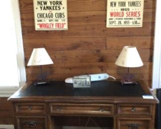 Kneehole desk with leather top with gold detailing; Vintage baseball posters