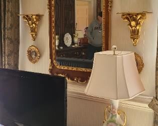 Several of these burled wood and gilt mirrors. 