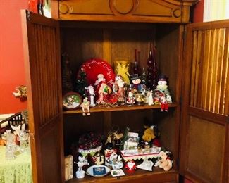 Holiday decorations perch in a double-door cabinet