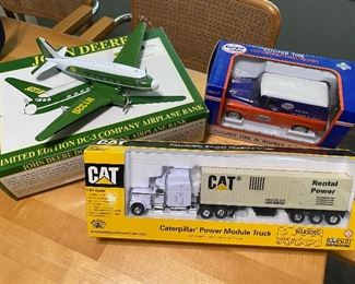 John Deere Collectable DC-3 Company Airplane Bank, Collectable Caterpillar Power Module Truck, Collectable Cooper Tire 1957 Chevrolet Panel Delivery Toy Truck