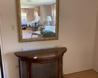 gilt-framed mid century wall mirror                                                                                                     credenza with conforming glass front