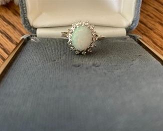 Genuine opal surrounded by 14 diamonds mounted in 14K 