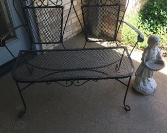 Metal bench, concrete statue