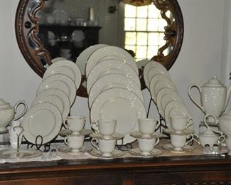 Complete Vintage Lenox "Fruits of Life" China Set. Includes a Four Piece Place Setting, Service for 8, (Dinner and Salad Plates and Cup and Saucer) and Several Serving Pieces including Coffee Pot, Tea Pot, Creamer and Sugar. Also Available Sold Separately are a set of 8 Dinner Plates and 8 Salad Plates.