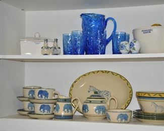 Top Shelf includes a Emma Bridgewater, Made in England, 2-Pc. Butter Dish and a "Pudding Bowl" Shown with a Vintage Seneca, Driftwood Blue Glass Pitcher and 4 oz. JuiceGlasses. On the Bottom Shelf is Fantastic Painted Ceramic Ware,, by Ros Byrne, Made in Zimbabwe. 18-Piece Set