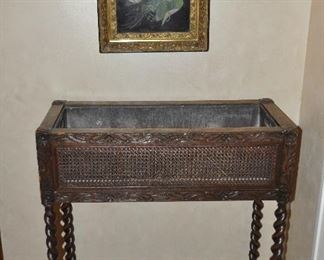 Carved Jardiniere in Caned Oak with Liner. W30" x H34" x D12.75". Also shown, an Antique Oil on Tin "Water Lillies" c.1880