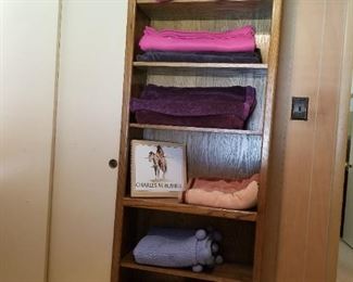 One of several bookshelves with selection of throws
