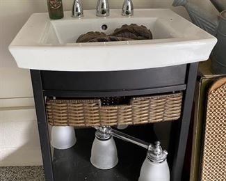 Sink with drawer, vintage Dr Pepper bottle, light fixture 
