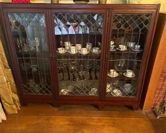 Victorian Mohagany Bookcase. Rectangular top over three leaded and glazed cupboard doors enclosing shelves, set on bracket feet. American. Height 52", width 59 1/2", depth 12".