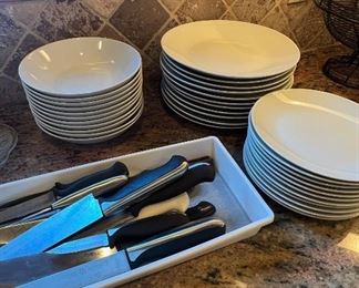 White dishes, knives, utensils
