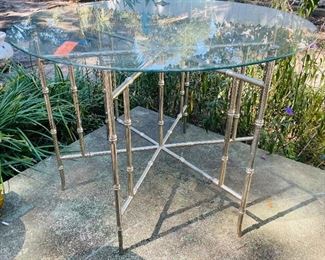 $250 
Round metal bamboo table 36"Diam glass top&nbsp;