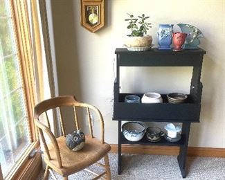 Antique armchair, shelf with grow light, Seth Thomas Regulator wall clock. 