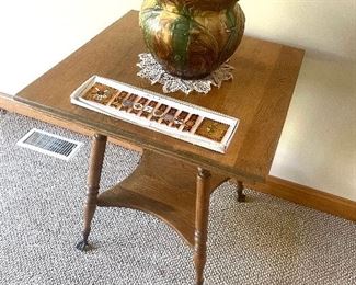 Antique oak parlor table with claw  and ball feet. Art pottery jardiniere. 