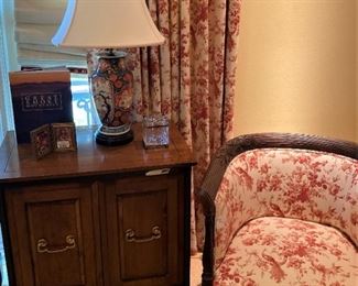 Side table; lamp; toile upholstered chair (Matching window treatments remain with the house.)