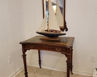 English Writing Desk with leather top, coved bay writing surface with unique Arrow Brass Pulls. Working model ship with correct rigging. Period Chippendale Mirror.