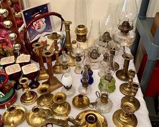 Large Alladin oil lamp as well as several others and a nice assortment of brass candlesticks.