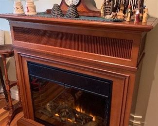 Stand alone fire place with remote, manger, mantle clock