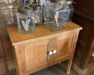Antique oak cabinet, multiple sizes of daisy churns 